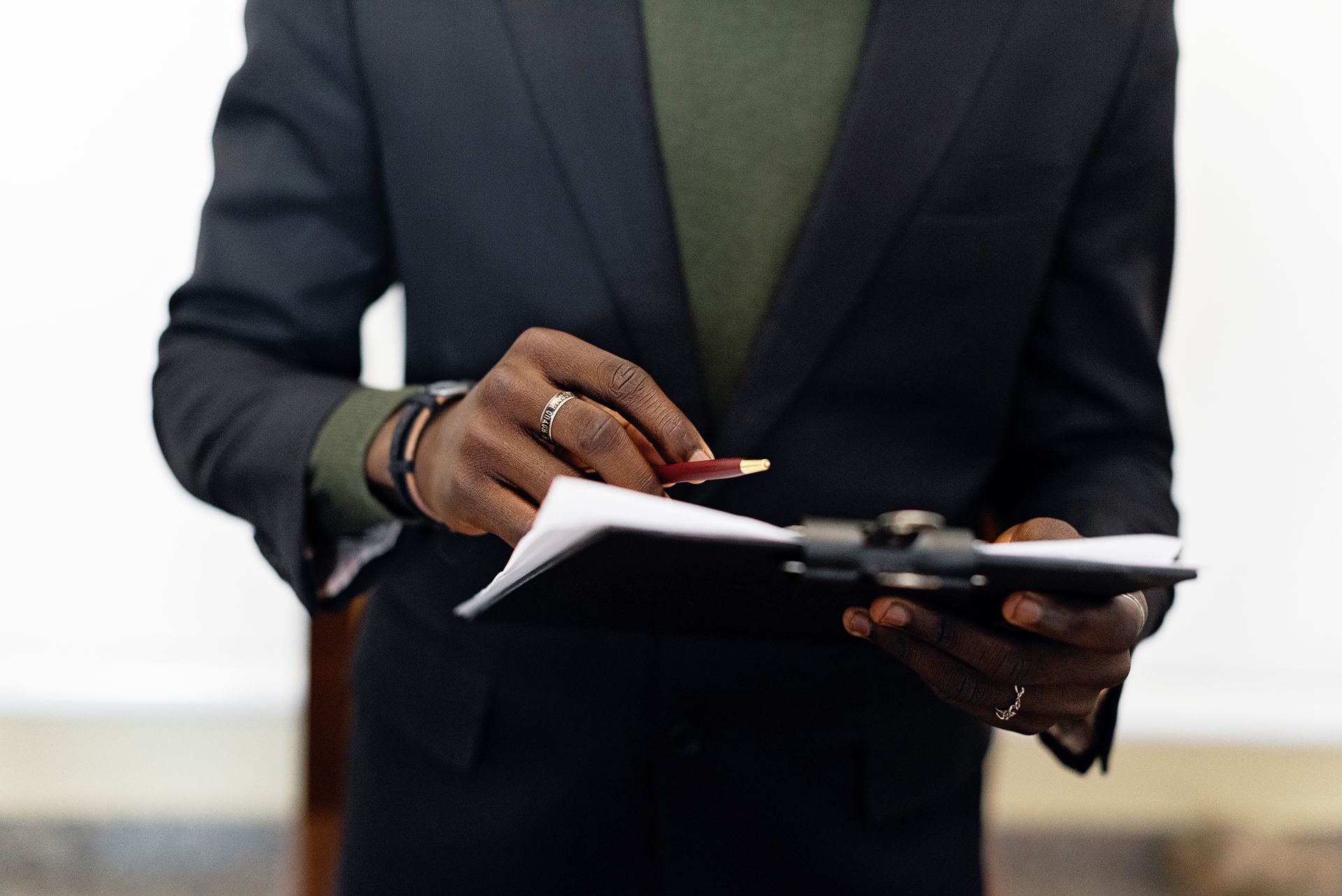 Professional in an office holding a compliance checklist on a clipboard